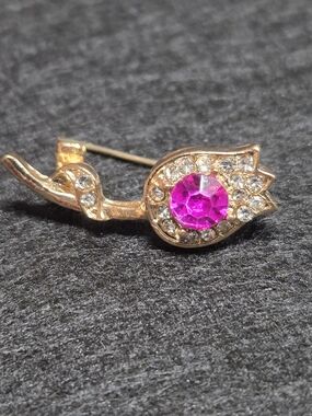 **Gold-Tone Swan Brooch with Pink Crystal Center**
